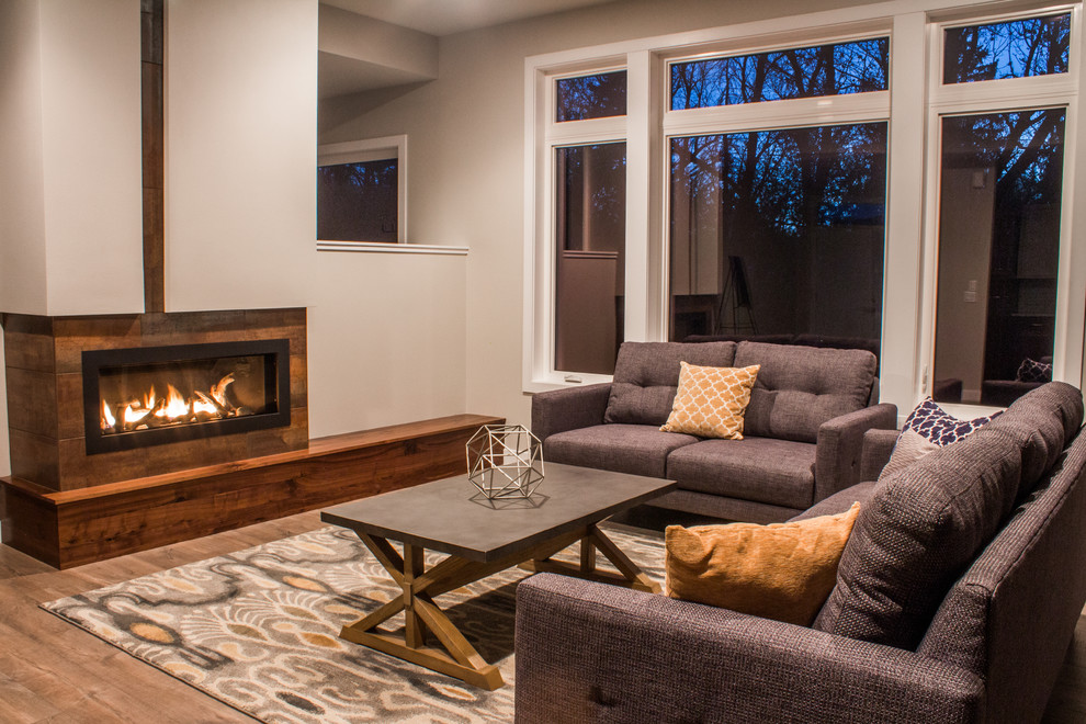 This is an example of a contemporary open concept living room in Other with white walls, light hardwood floors, a ribbon fireplace and a wall-mounted tv.