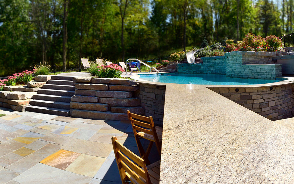 Example of a large transitional backyard stone and custom-shaped water slide design in Detroit