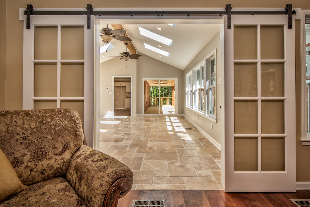 Photo of a large traditional sunroom in Other with travertine floors, no fireplace, a standard ceiling and beige floor.