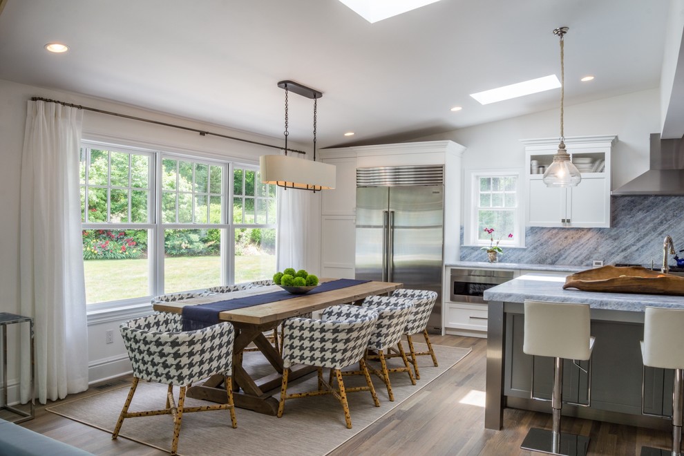 Great room - mid-sized transitional medium tone wood floor and brown floor great room idea in New York with white walls and no fireplace