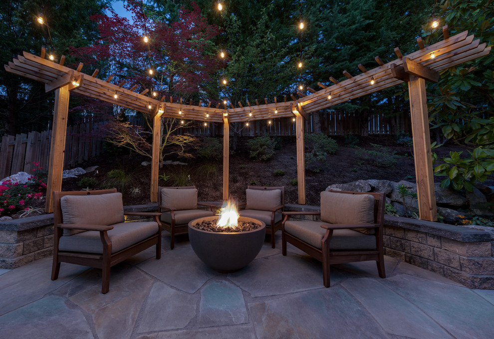 Design ideas for a large transitional backyard patio in Seattle with a fire feature, concrete slab and no cover.