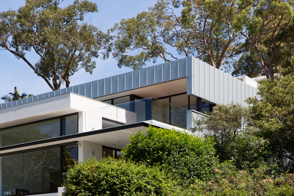 Inspiration for a large contemporary three-storey exterior in Sydney with a flat roof.