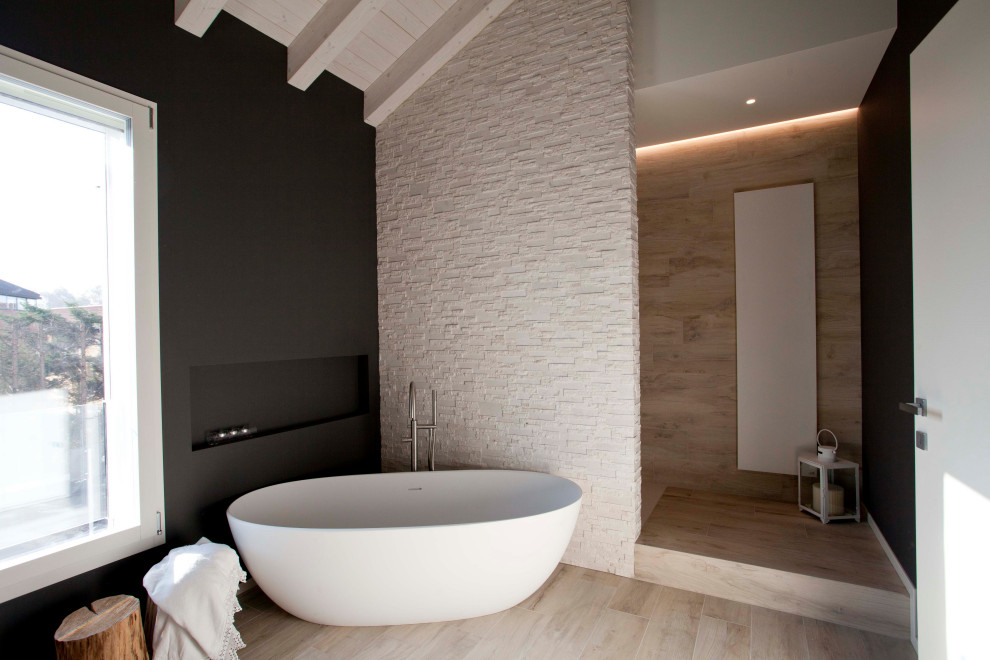 Inspiration for a large contemporary master bathroom in Other with a freestanding tub, beige tile, black walls and beige floor.