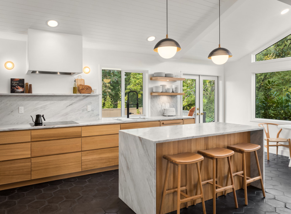 This is an example of a midcentury kitchen in Portland with flat-panel cabinets, with island, black floor, exposed beam, timber, vaulted, light wood cabinets, marble benchtops, marble splashback and terra-cotta floors.