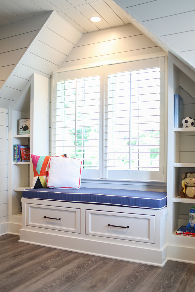 This is an example of a large transitional kids' bedroom for kids 4-10 years old and boys in Charlotte with white walls and medium hardwood floors.
