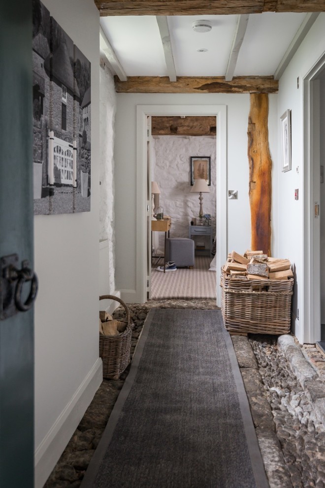 Mid-sized country hallway in Devon with white walls and grey floor.