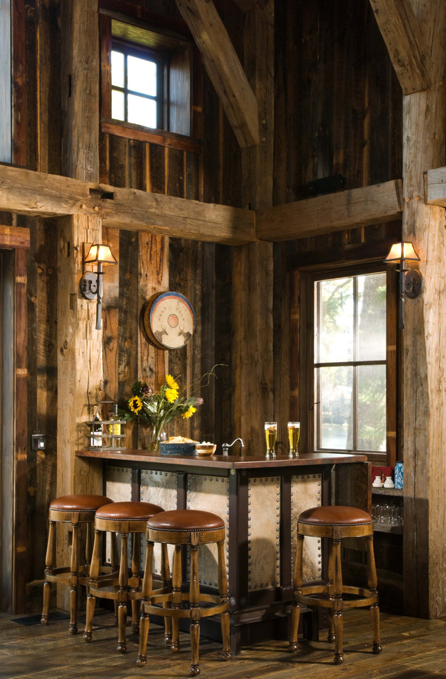 Photo of a small country l-shaped seated home bar in Denver with dark hardwood floors.