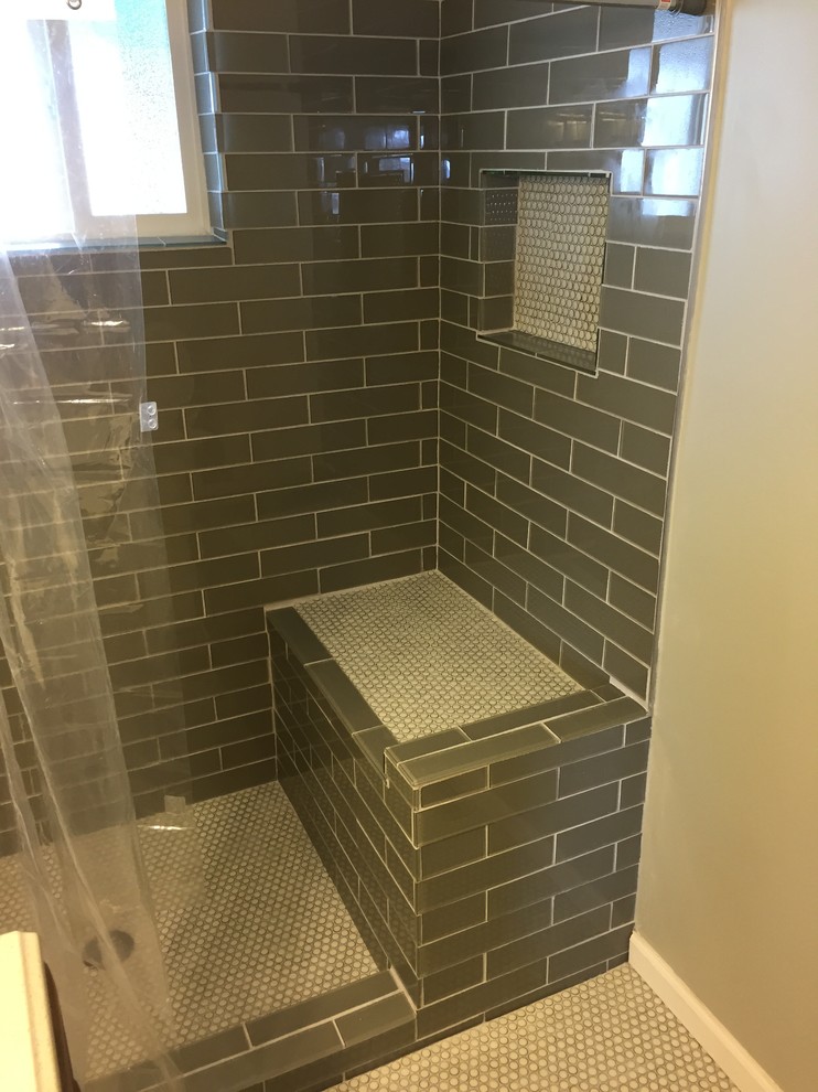 Small modern master bathroom in Indianapolis with an integrated sink, raised-panel cabinets, medium wood cabinets, engineered quartz benchtops, an open shower, a two-piece toilet, gray tile, glass tile, grey walls and mosaic tile floors.