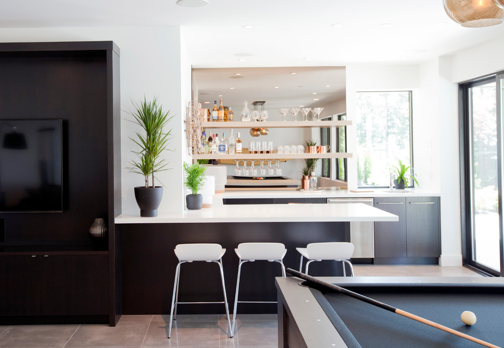 Photo of a mid-sized contemporary u-shaped seated home bar in Vancouver with an undermount sink, flat-panel cabinets, dark wood cabinets, quartz benchtops, mirror splashback and porcelain floors.