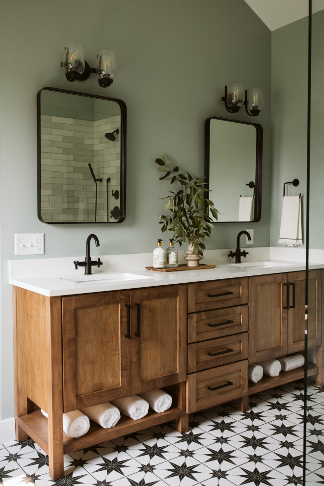 Inspiration for a large cottage master ceramic tile, multicolored floor, double-sink and vaulted ceiling bathroom remodel in Grand Rapids with shaker cabinets, medium tone wood cabinets, green walls, an undermount sink, quartz countertops, white countertops, a niche and a built-in vanity