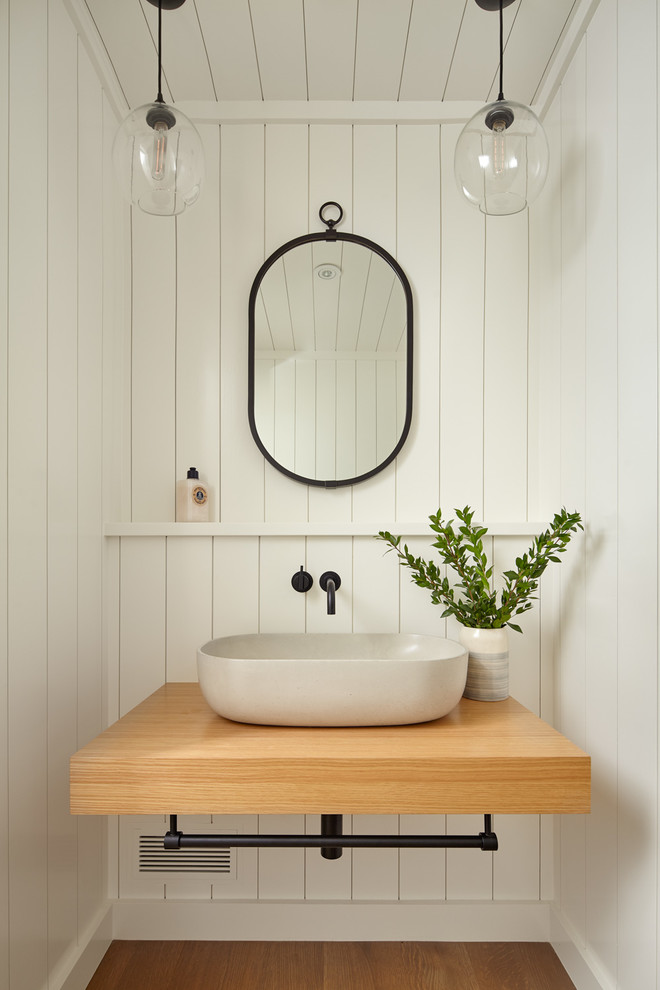 Design ideas for a transitional powder room in San Francisco with white walls, medium hardwood floors, a vessel sink and wood benchtops.