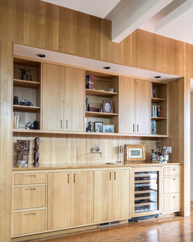Photo of a contemporary single-wall wet bar in Sacramento with an undermount sink, flat-panel cabinets, light wood cabinets, wood benchtops, brown splashback, timber splashback and medium hardwood floors.