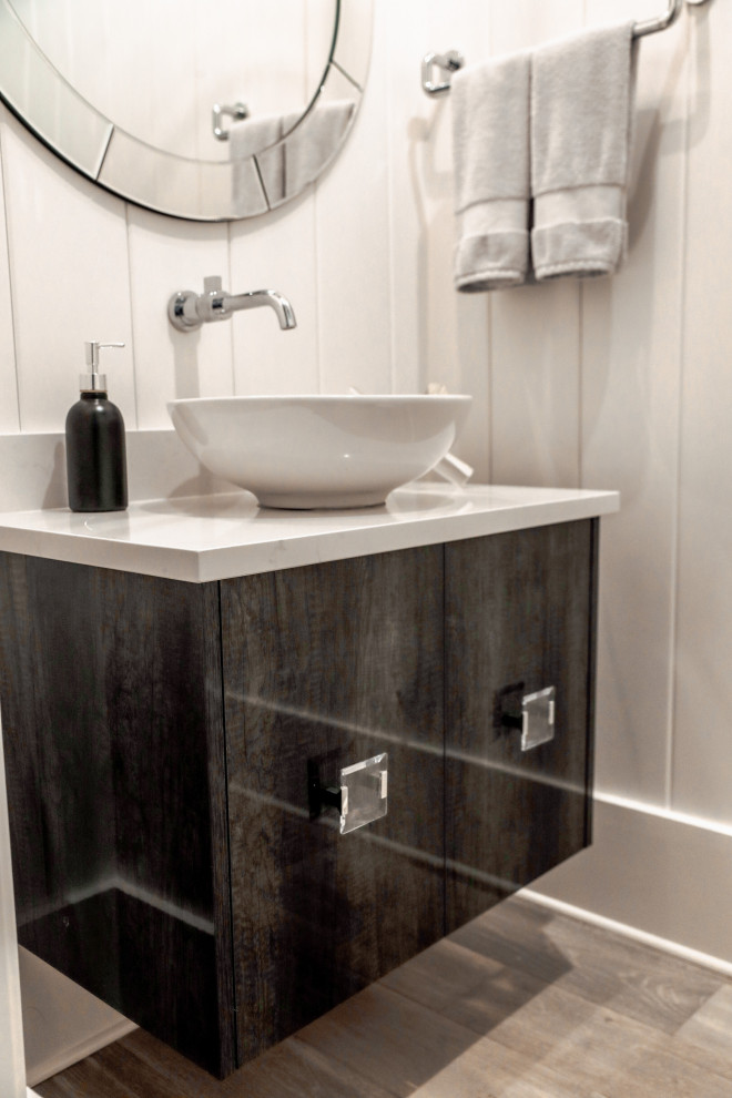 This is an example of a small coastal cloakroom in Other with glass-front cabinets, grey cabinets, light hardwood flooring, a vessel sink, quartz worktops, brown floors, white worktops, a floating vanity unit, a drop ceiling and wood walls.