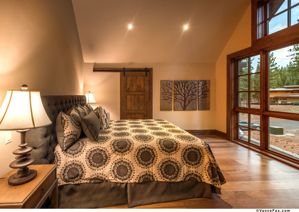 Inspiration for a large transitional master bedroom in Sacramento with beige walls, light hardwood floors and no fireplace.
