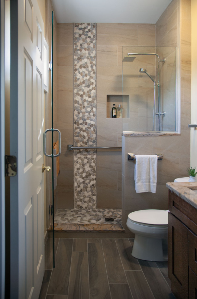 Design ideas for a small transitional 3/4 bathroom in Other with shaker cabinets, brown cabinets, an open shower, a one-piece toilet, black tile, ceramic tile, beige walls, ceramic floors, an undermount sink, granite benchtops, brown floor, a hinged shower door and beige benchtops.
