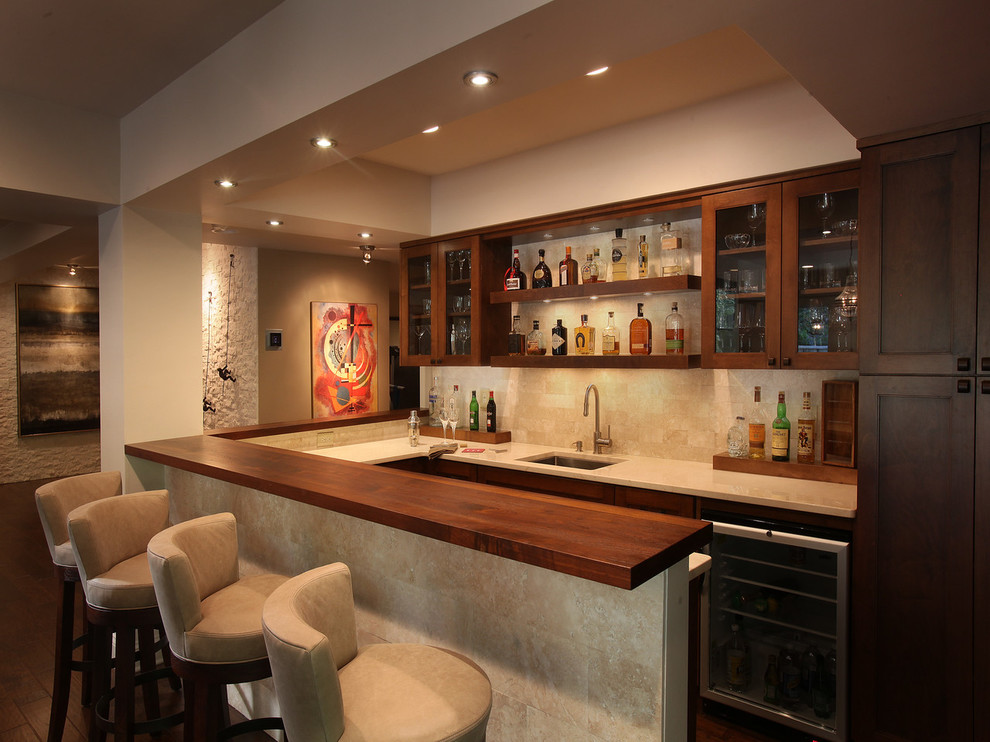 This is an example of a large transitional u-shaped seated home bar in Atlanta with an undermount sink, open cabinets, dark wood cabinets, beige splashback, quartz benchtops, medium hardwood floors and brown floor.