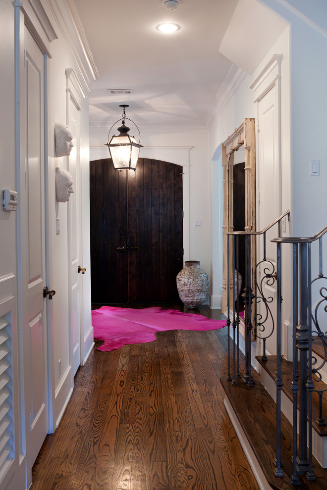 Design ideas for a transitional entryway in Houston with a dark wood front door, a double front door and brown floor.