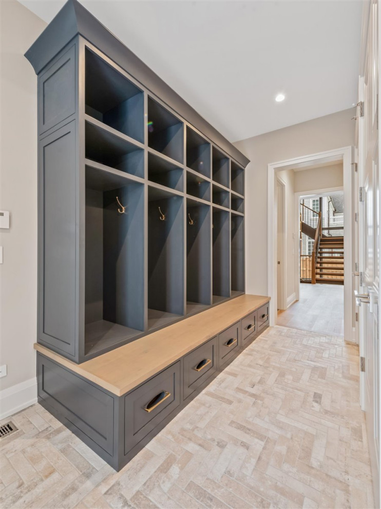 Design ideas for a mid-sized transitional mudroom in Chicago with grey walls, ceramic floors and brown floor.