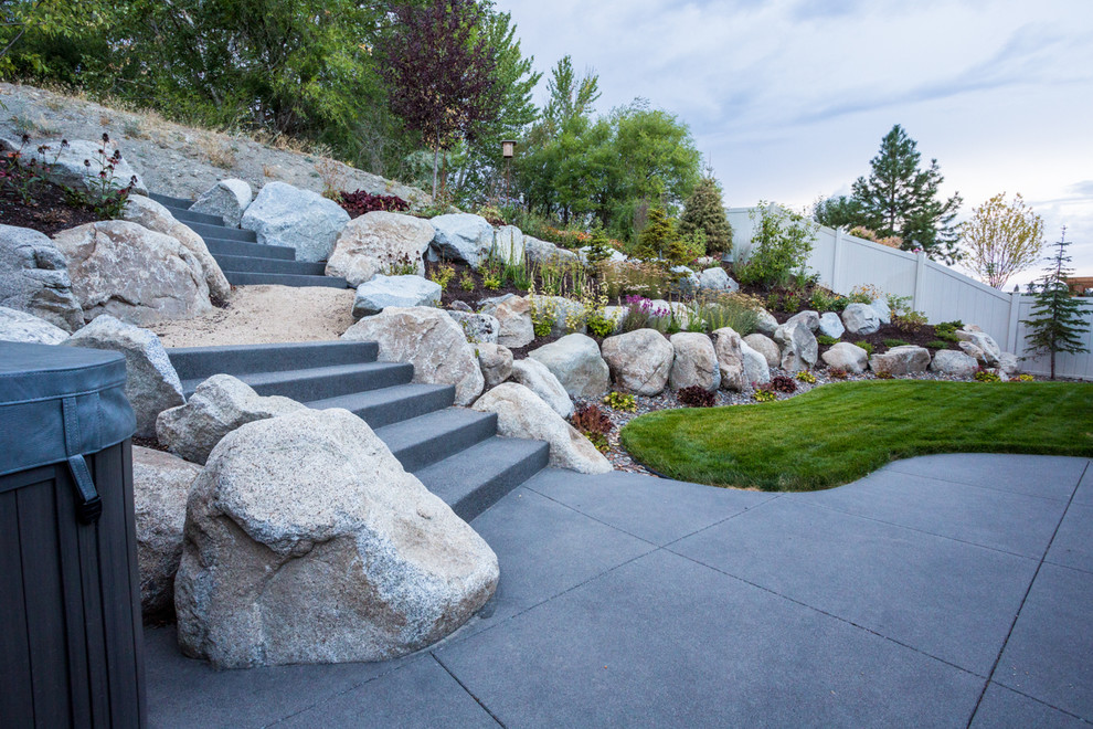 This is an example of a small transitional backyard retaining wall landscape.