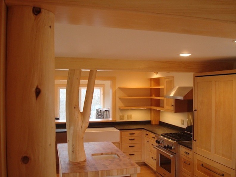 Inspiration for a mid-sized l-shaped medium tone wood floor eat-in kitchen remodel with medium tone wood cabinets, solid surface countertops, stainless steel appliances and an island