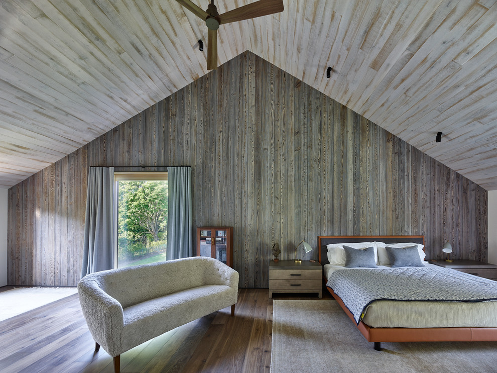 Country bedroom in New York with dark hardwood floors and brown floor.