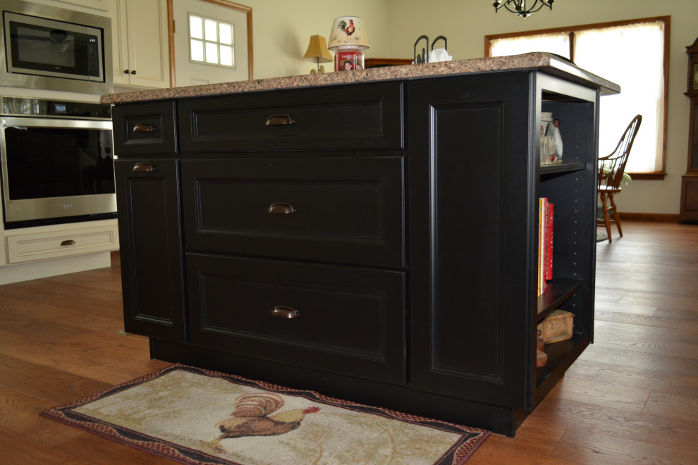 Eat-in kitchen - small transitional l-shaped medium tone wood floor and brown floor eat-in kitchen idea with an undermount sink, flat-panel cabinets, beige cabinets, quartz countertops, stainless steel appliances, an island and brown countertops