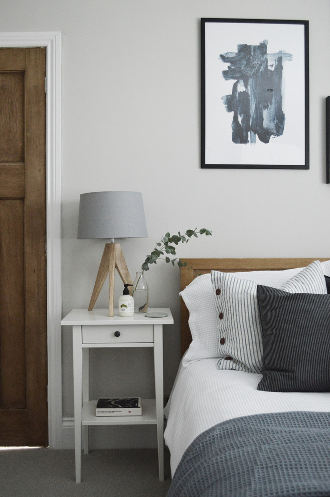 This is an example of a small scandinavian guest bedroom in Other with grey walls, carpet, no fireplace and grey floor.