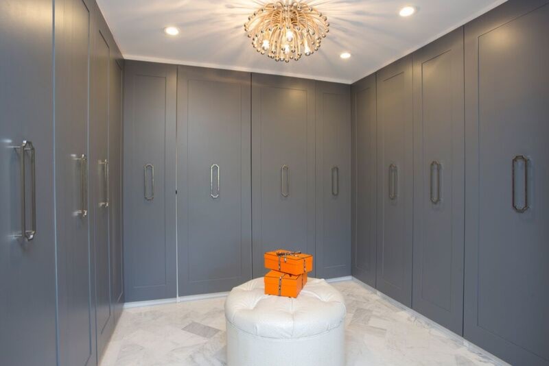 This is an example of a large eclectic gender-neutral walk-in wardrobe in Los Angeles with shaker cabinets, grey cabinets and marble floors.