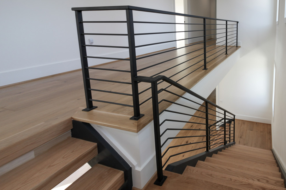 Inspiration for a mid-sized contemporary wood straight staircase in DC Metro with metal railing.