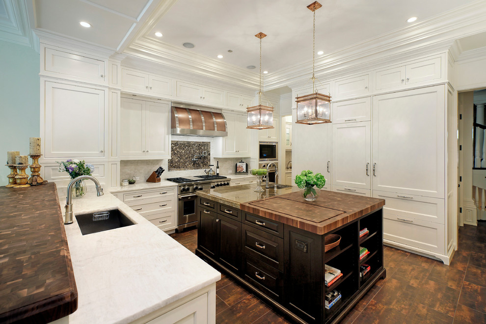 This is an example of an expansive traditional u-shaped eat-in kitchen in Chicago with an undermount sink, stainless steel appliances, dark hardwood floors, with island, shaker cabinets, white cabinets, marble benchtops, white splashback and stone slab splashback.