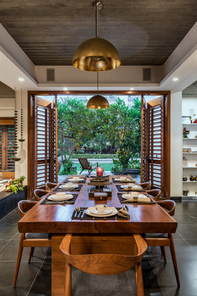 Design ideas for a tropical dining room in Other.