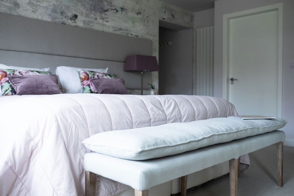 This is an example of a medium sized modern master and grey and purple bedroom in Kent with pink walls, carpet, grey floors, wallpapered walls and a feature wall.