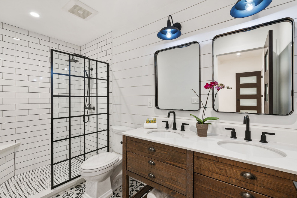 This is an example of a large transitional 3/4 bathroom in San Francisco with medium wood cabinets, an alcove shower, a two-piece toilet, white tile, subway tile, multi-coloured walls, an undermount sink, an open shower, white benchtops, a shower seat, a double vanity, a built-in vanity and flat-panel cabinets.