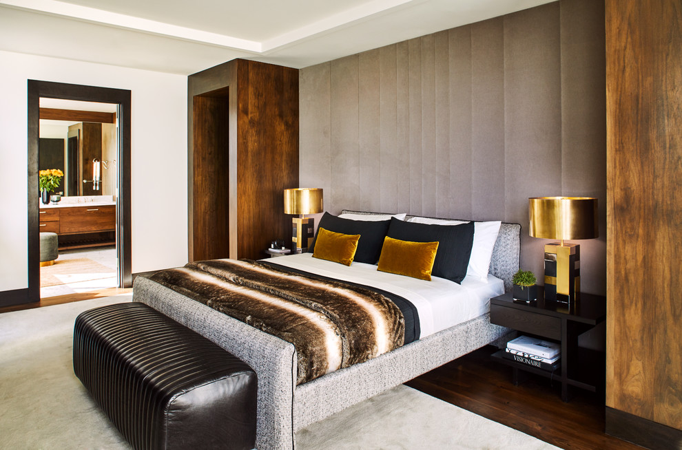 Photo of a contemporary bedroom in Los Angeles with grey walls, dark hardwood floors and brown floor.