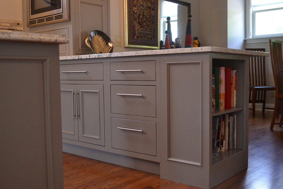 Large transitional l-shaped medium tone wood floor open concept kitchen photo in Cincinnati with an undermount sink, gray cabinets, granite countertops, multicolored backsplash, mosaic tile backsplash, stainless steel appliances, an island and beaded inset cabinets