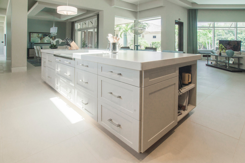 Inspiration for a large transitional l-shaped kitchen pantry remodel in Miami with shaker cabinets, dark wood cabinets, quartz countertops, beige backsplash, paneled appliances and an island