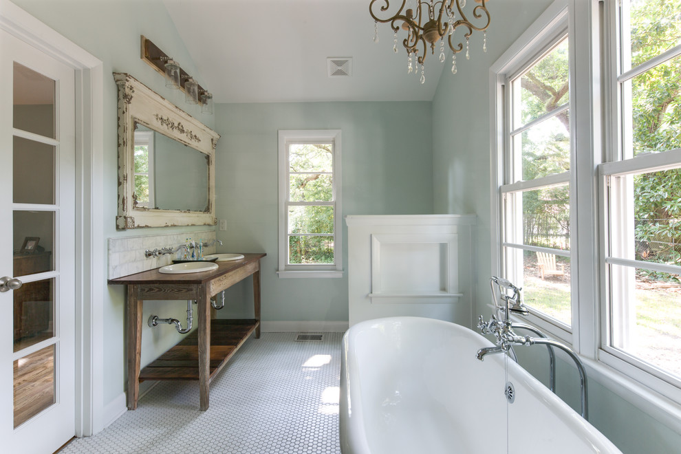 Design ideas for a mid-sized country bathroom in Charleston with a drop-in sink, a freestanding tub, blue walls, mosaic tile floors, distressed cabinets, open cabinets, gray tile, marble and white floor.