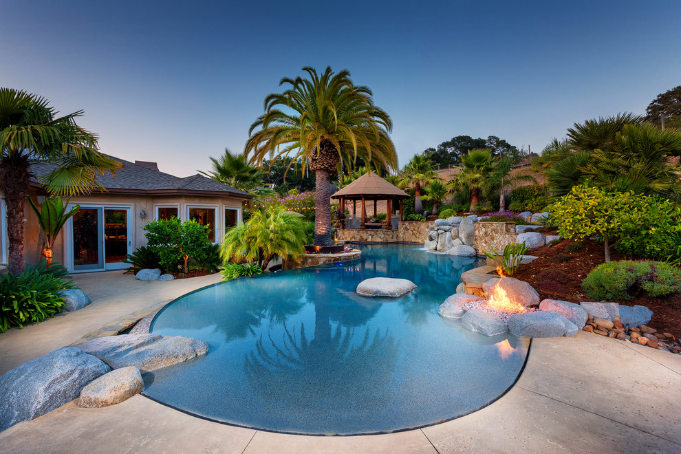 Tropical backyard custom-shaped lap pool in San Francisco with concrete slab.