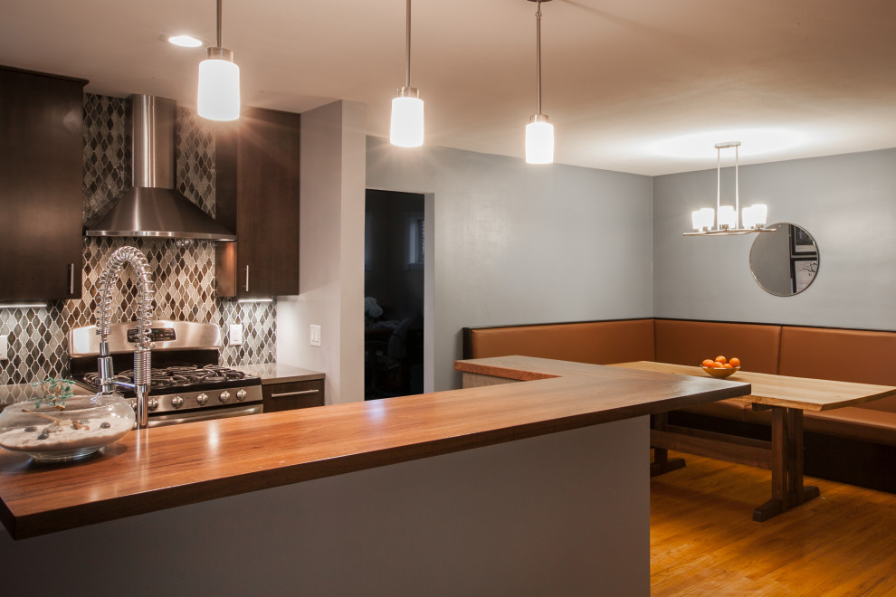 Eat-in kitchen - transitional galley cork floor and gray floor eat-in kitchen idea with an undermount sink, flat-panel cabinets, dark wood cabinets, quartz countertops, mosaic tile backsplash, stainless steel appliances and a peninsula