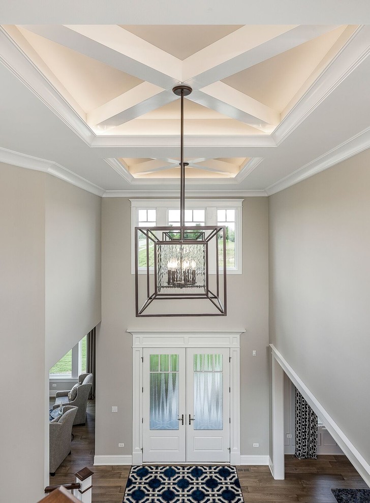 Design ideas for a mid-sized transitional foyer in Chicago with beige walls, dark hardwood floors, a double front door, a white front door and brown floor.