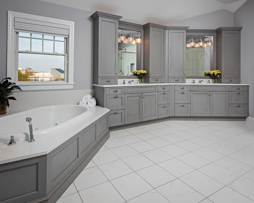 Drop-in bathtub - huge transitional drop-in bathtub idea with recessed-panel cabinets, gray cabinets, an undermount sink and quartz countertops