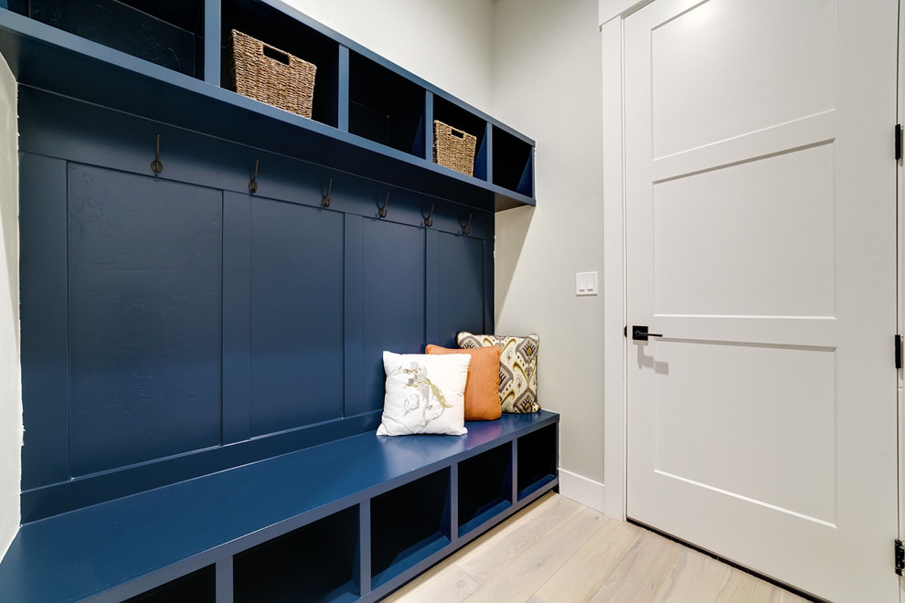 Design ideas for a mid-sized arts and crafts mudroom in Boise with grey walls, light hardwood floors, a single front door, a white front door and beige floor.