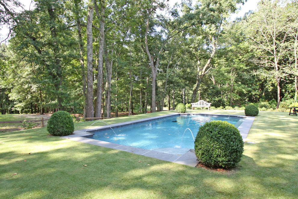 Mid-sized traditional backyard rectangular lap pool in Atlanta with a water feature.