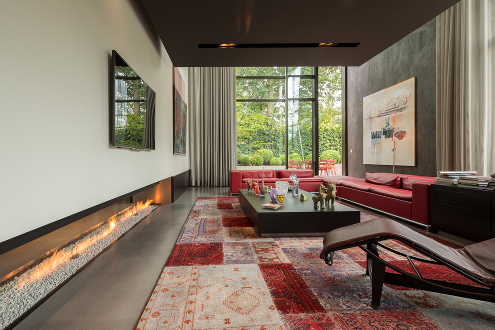 Contemporary living room in Other with white walls, concrete floors, a ribbon fireplace and a wall-mounted tv.