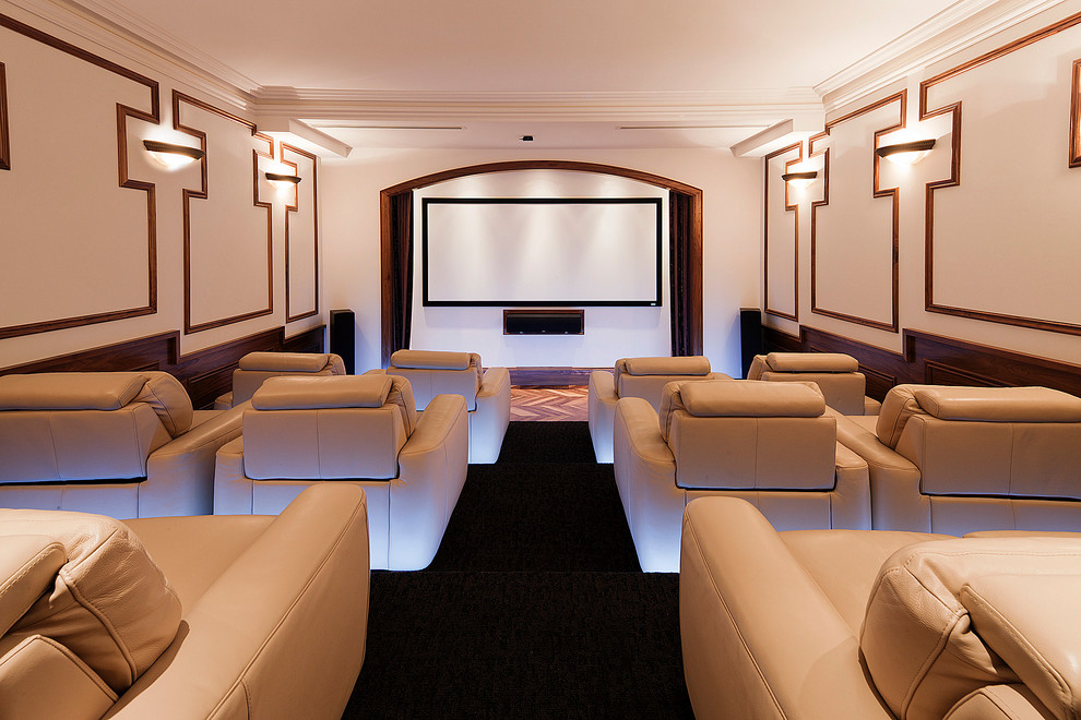 This is an example of a large transitional enclosed home theatre in Melbourne with white walls, carpet, a projector screen and black floor.
