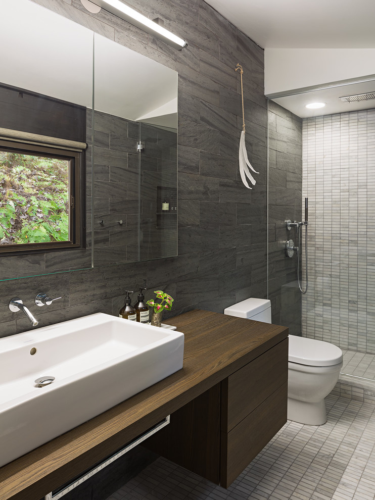 Design ideas for a midcentury bathroom in Philadelphia with a vessel sink, flat-panel cabinets, dark wood cabinets, an alcove shower, gray tile and slate.