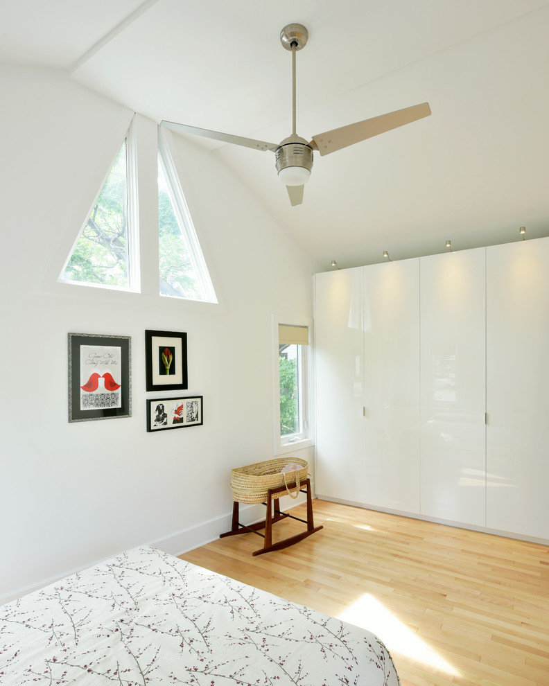 Mid-sized scandinavian master bedroom in Ottawa with white walls and light hardwood floors.