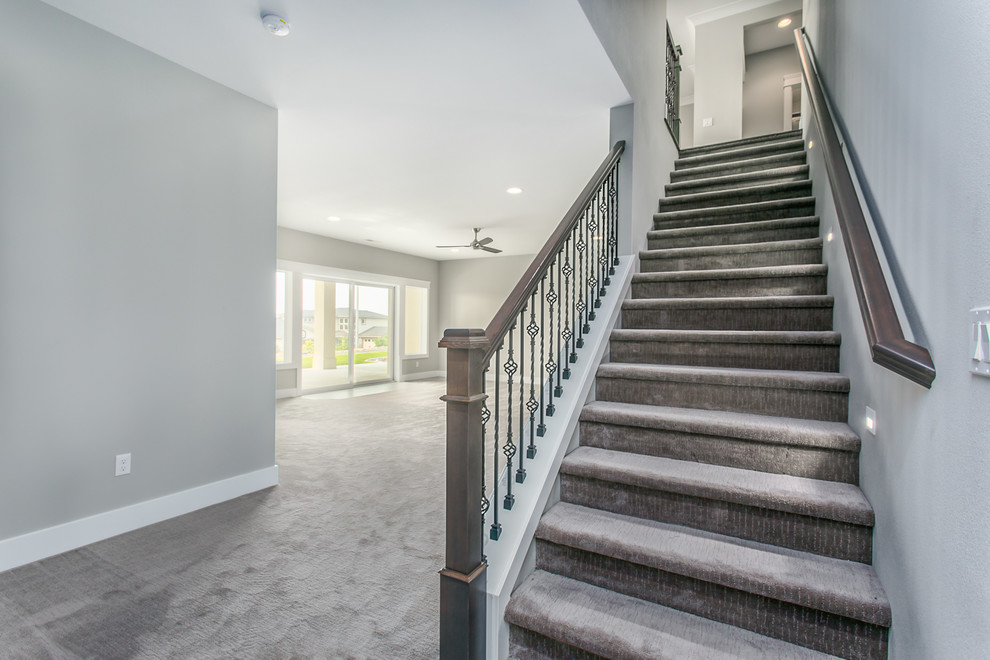 Inspiration for a large transitional walk-out carpeted and gray floor basement remodel in Seattle with gray walls and no fireplace
