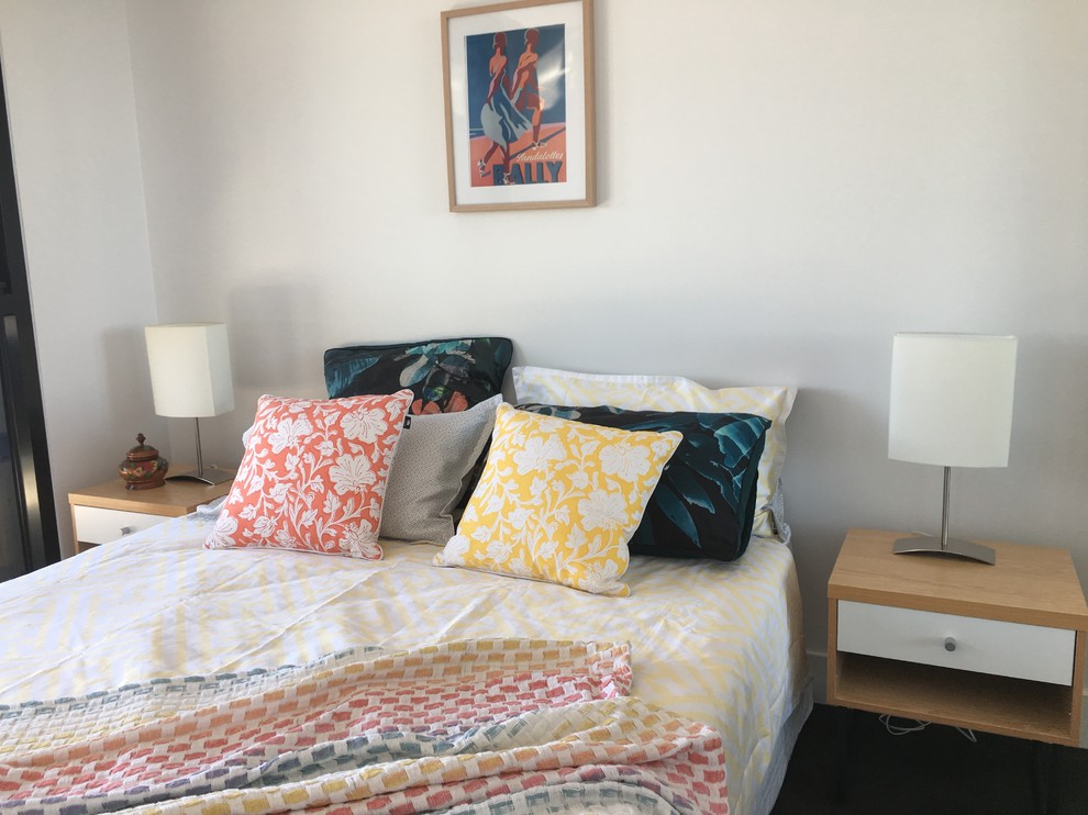 Photo of a small scandinavian guest bedroom in Melbourne with white walls and carpet.