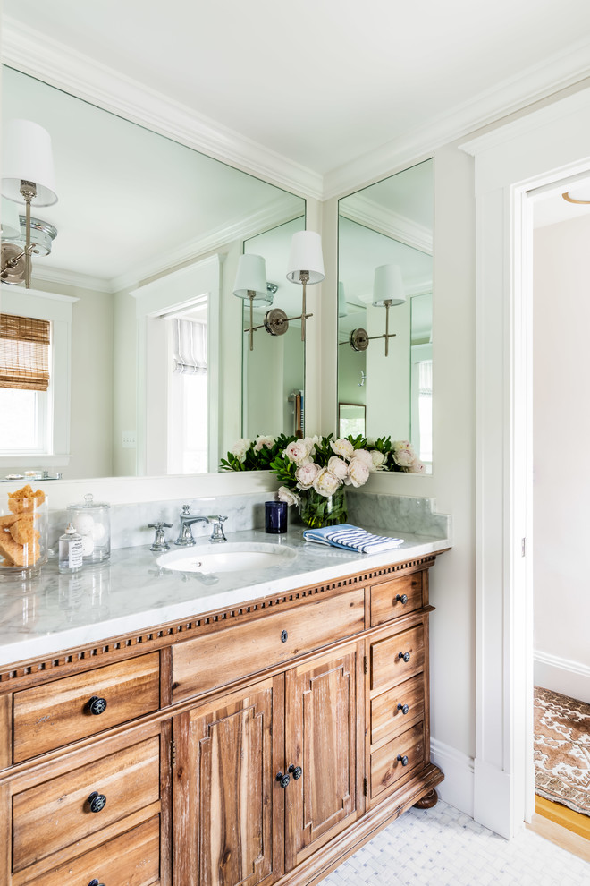 This is an example of a small traditional master bathroom in Boston with medium wood cabinets, grey walls, marble floors, an undermount sink, marble benchtops, grey floor, white benchtops and recessed-panel cabinets.